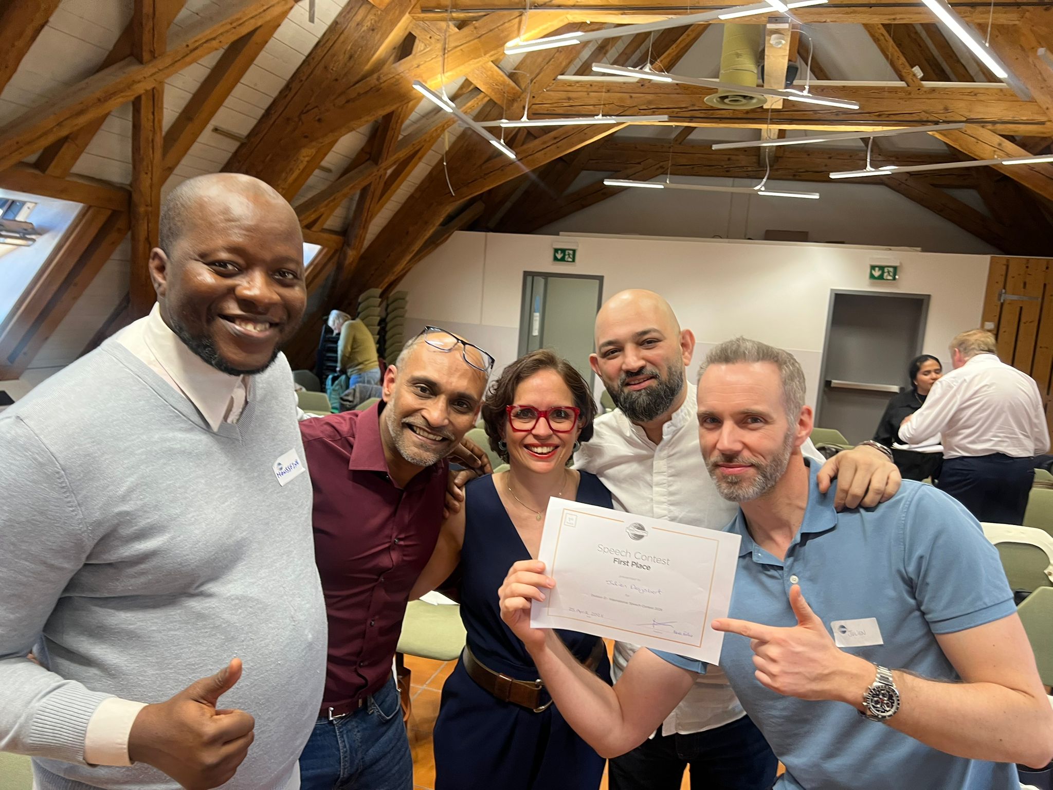 Impact Toastmasters members welcoming guests at a meeting